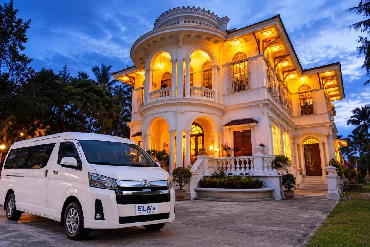 A white ELA's van outside a lit-up heritage mansion at dusk