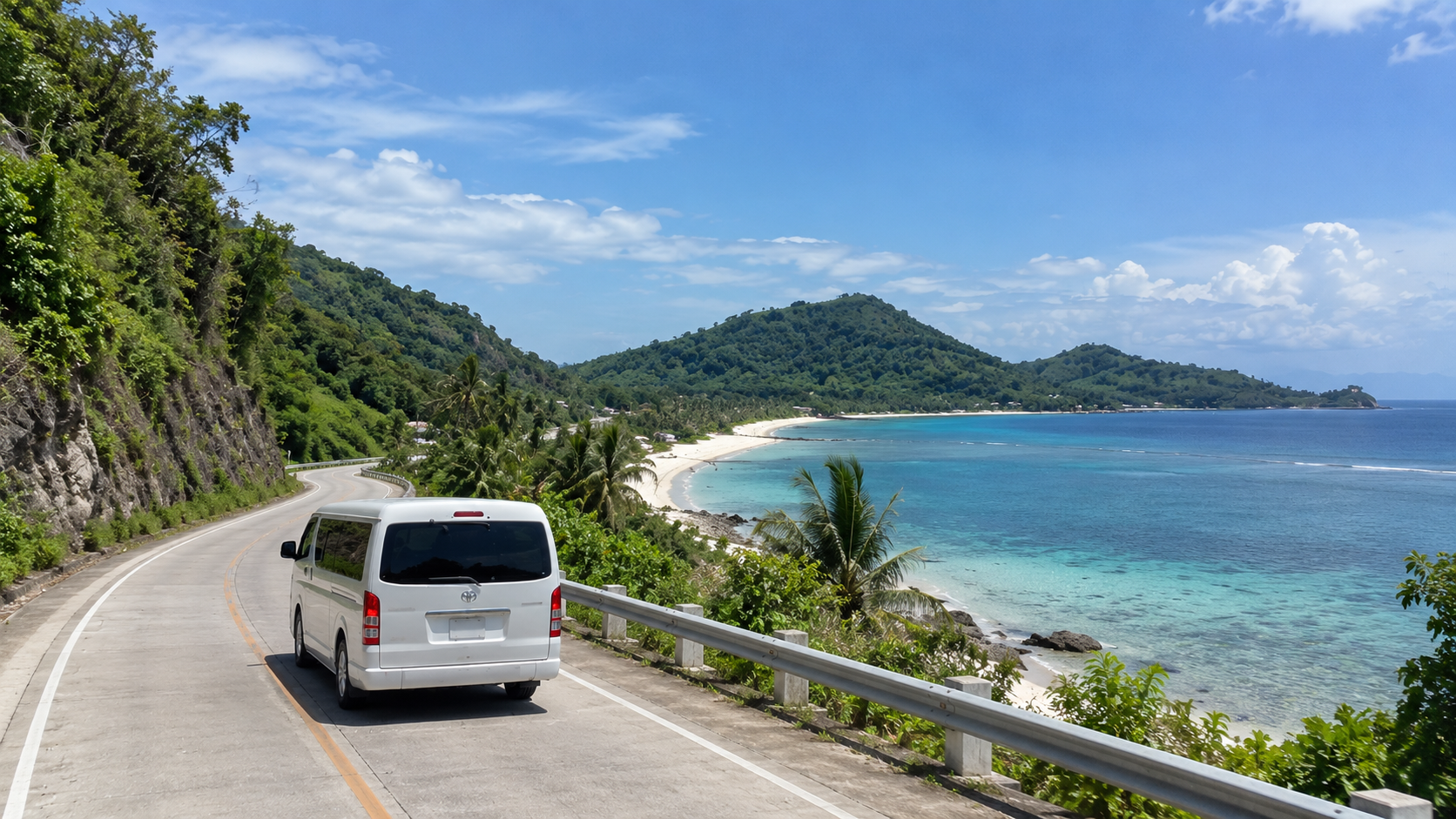 A white van on a coastal road above a beach and green hills