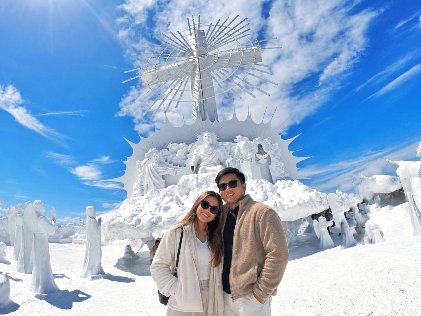 A couple in front of the white heaven sculptures and cross at Garin Farm